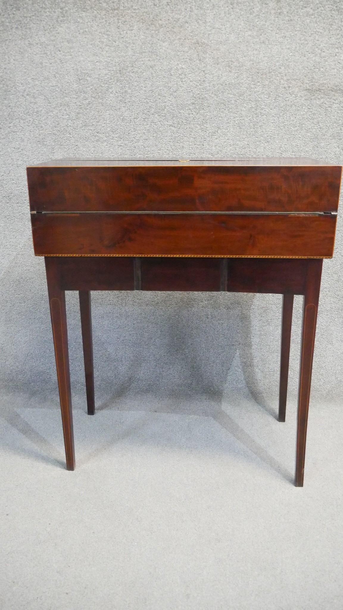 A 19th century mahogany and satinwood inlaid fold out writing desk with fitted interior on base with