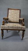 A late 19th century walnut framed armchair in floral upholstery on turned tapering supports.