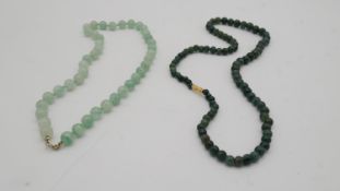 Two dyed green agate bead necklaces. One knotted with a secure C-sprung clasp and the other darker