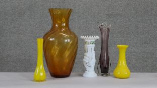 A collection of vintage and antique glass vases. Including two vintage opaque yellow glass vases, an
