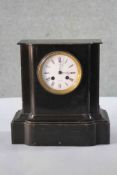 A late 19th century Continental ebonised mantle clock with eight day movement and white enamel