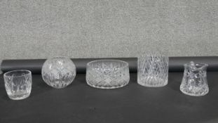 A collection of cut crystal items. Including a lemonade jug, globe shaped bowl, planter and other