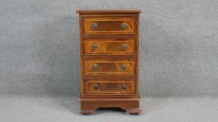 A small Georgian style flame mahogany and crossbanded pedestal chest with central floral inlay. H.78