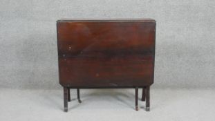 A C.1900 mahogany drop flap Sutherland table on square tapering supports terminating in brass