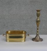 A twin handled brass rectangular planter along with a brass candle stick. H.28 W.10cm (largest)