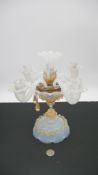 An opalescent and aventurine Murano glass four branch candelabra with glass drops and ruffled