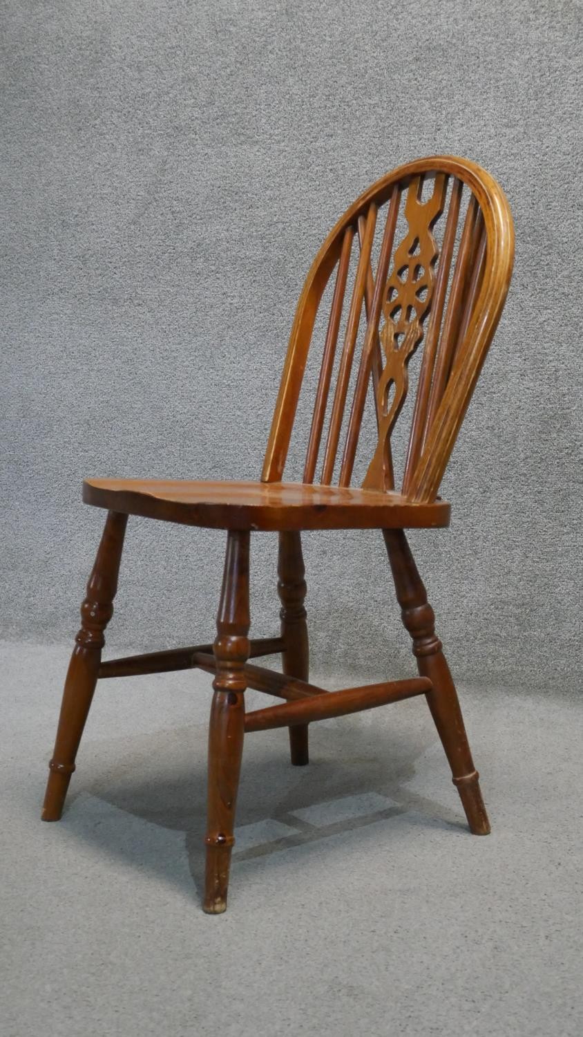 A set of four stained pine Windsor wheelback dining chairs. - Image 2 of 5