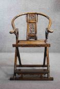 A Chinese huali folding scribes armchair with hooped back and intricately carved back splat and