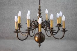 A Dutch style vintage twelve branch brass chandelier with scrolling design. H.100 W.65cm.