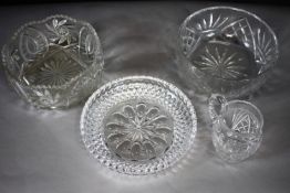 A collection of hand cut crystal. Including two fruit bowls, a serving dish and a water jug. Diam.