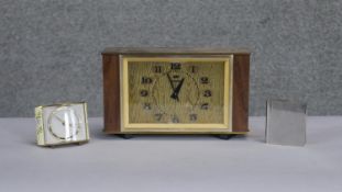 Three vintage clocks. Including a Vega brass and teak Art Deco mantle clock, a chrome book clock and