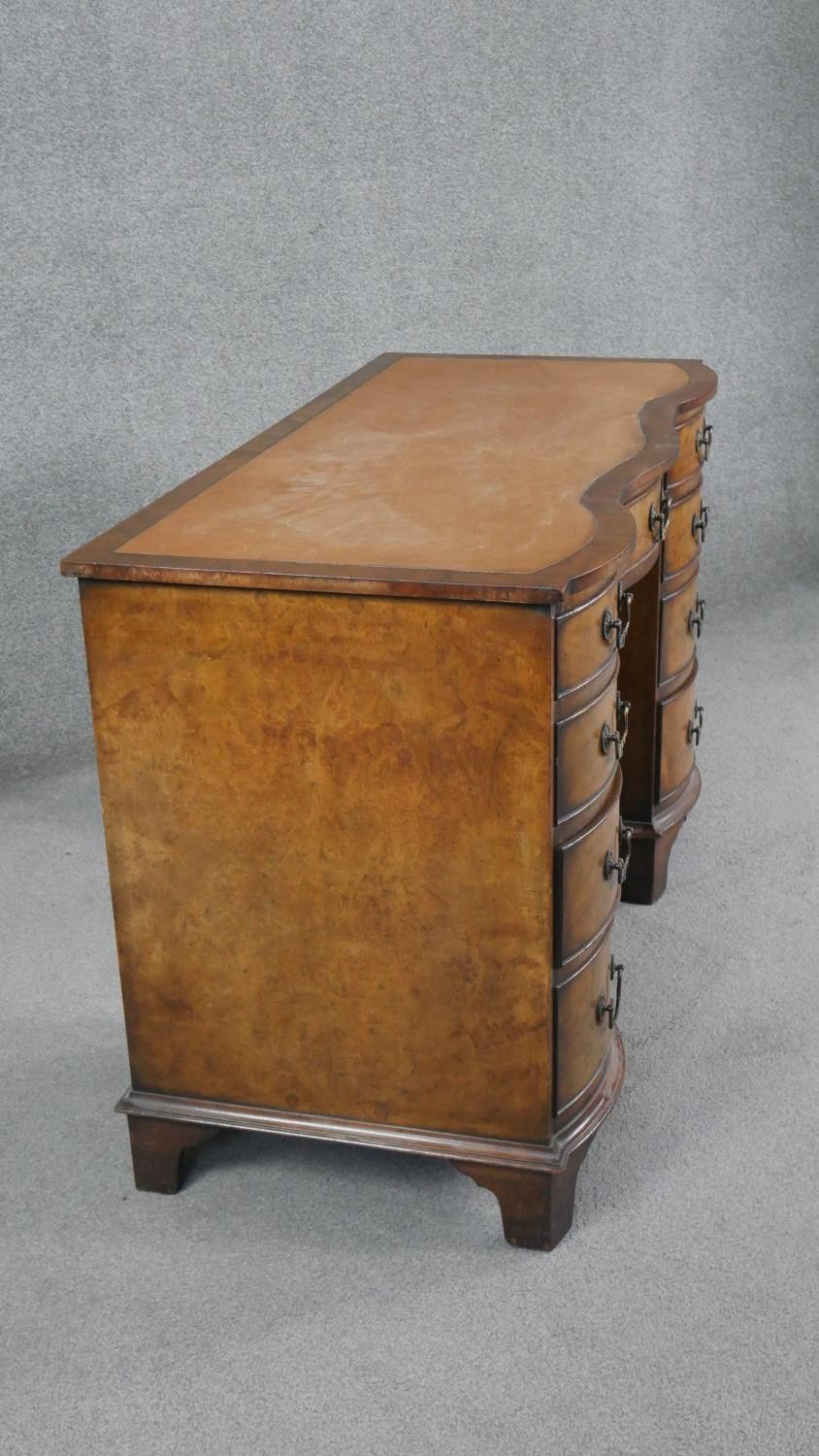 A Reprodux Georgian style figured mahogany pedestal desk with inset leather shaped top on shaped - Image 7 of 7