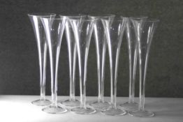 Eight Tiffany style blown clear glass trumpet design champagne flutes. H.29 Diameter. 8cm.