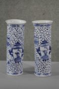 A pair of 19th century blue and white cylindrical Chinese vases. Decorated with figures, birds and