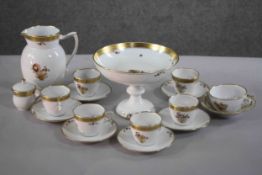 A six person Royal Copenhagen gilded and hand painted floral design coffee set. Along with