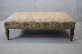 A large hearth stool in floral and wild animal weave upholstery raised on mahogany Regency style