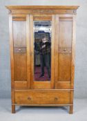 A mid century mirrored door wardrobe in the antique country oak style fitted with base drawer on