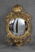 A Regency style gilt framed girandole with convex plate and foliate decoration and twin scrolling