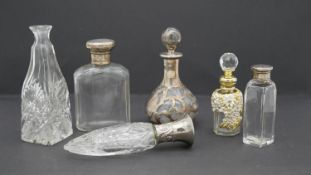 A collection of dressing table bottles and perfume bottles. Including a pierced silver and glass