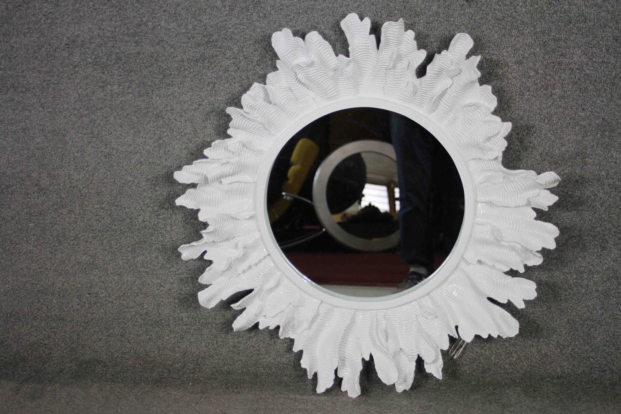 A large organic sculptural sunburst design fibreglass wall mirror. 87cm diameter.