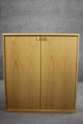 A contemporary light oak Musterring cabinet. H.100 W.90 D.45 cm.