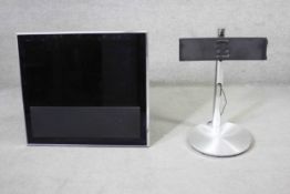 A Bang & Olufsen (33"inch) TV and powered brushed chrome stand.