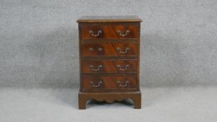A small Georgian style flame mahogany and crossbanded pedestal chest. H.63 W.44 D.33cm