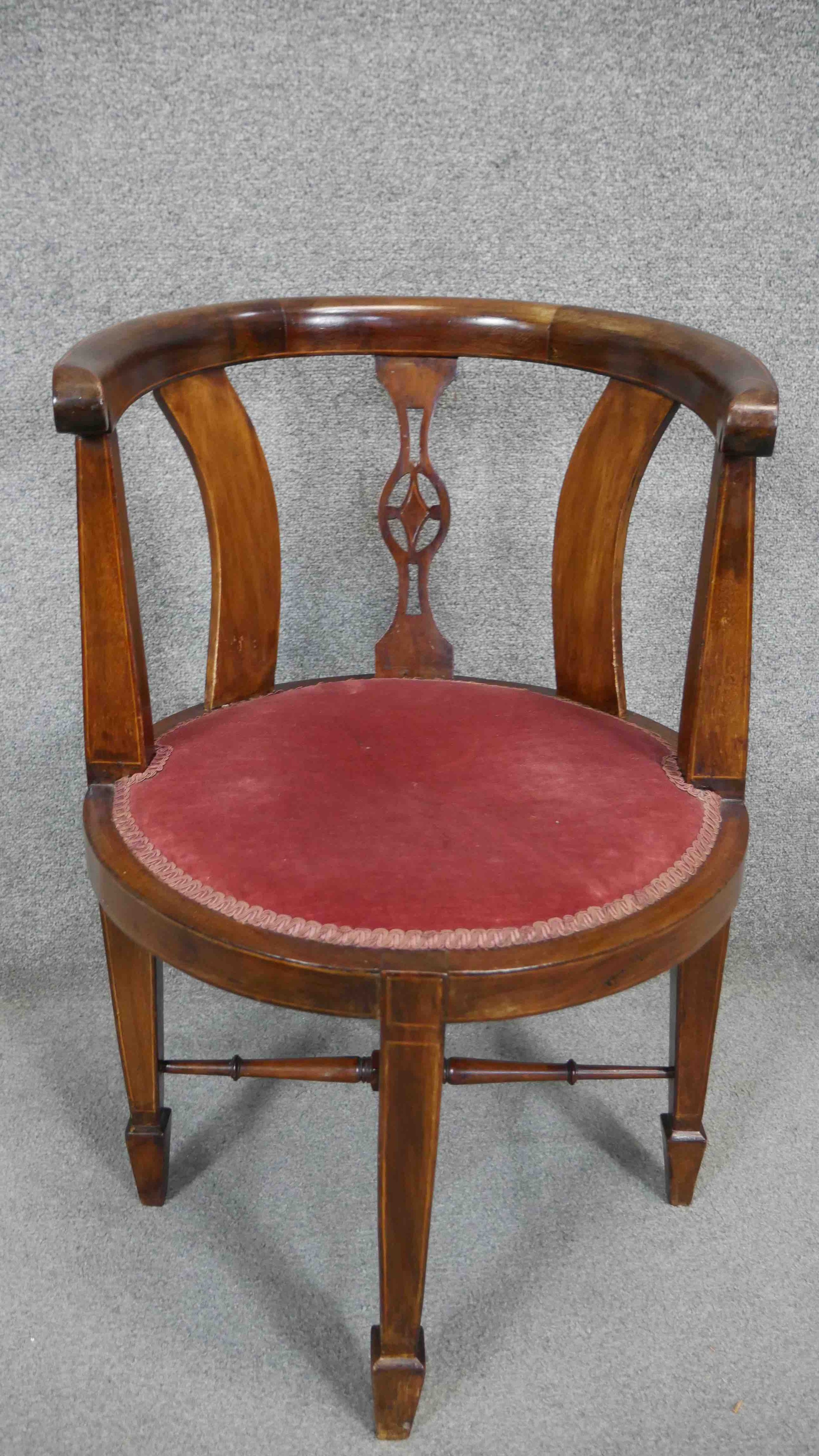 An Edwardian mahogany and satinwood inlaid tub armchair.