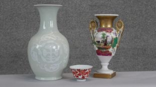 A Chinese celadon glaze vase with dragon motifs along with a hand painted twin handled porcelain urn
