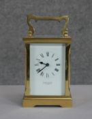 A Searle & Co limited brass and bevelled plate rectangular carriage clock with carrying handle.