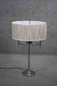 A chrome twin branched table lamp with pleated cream silk shade. H.70 W.44cm