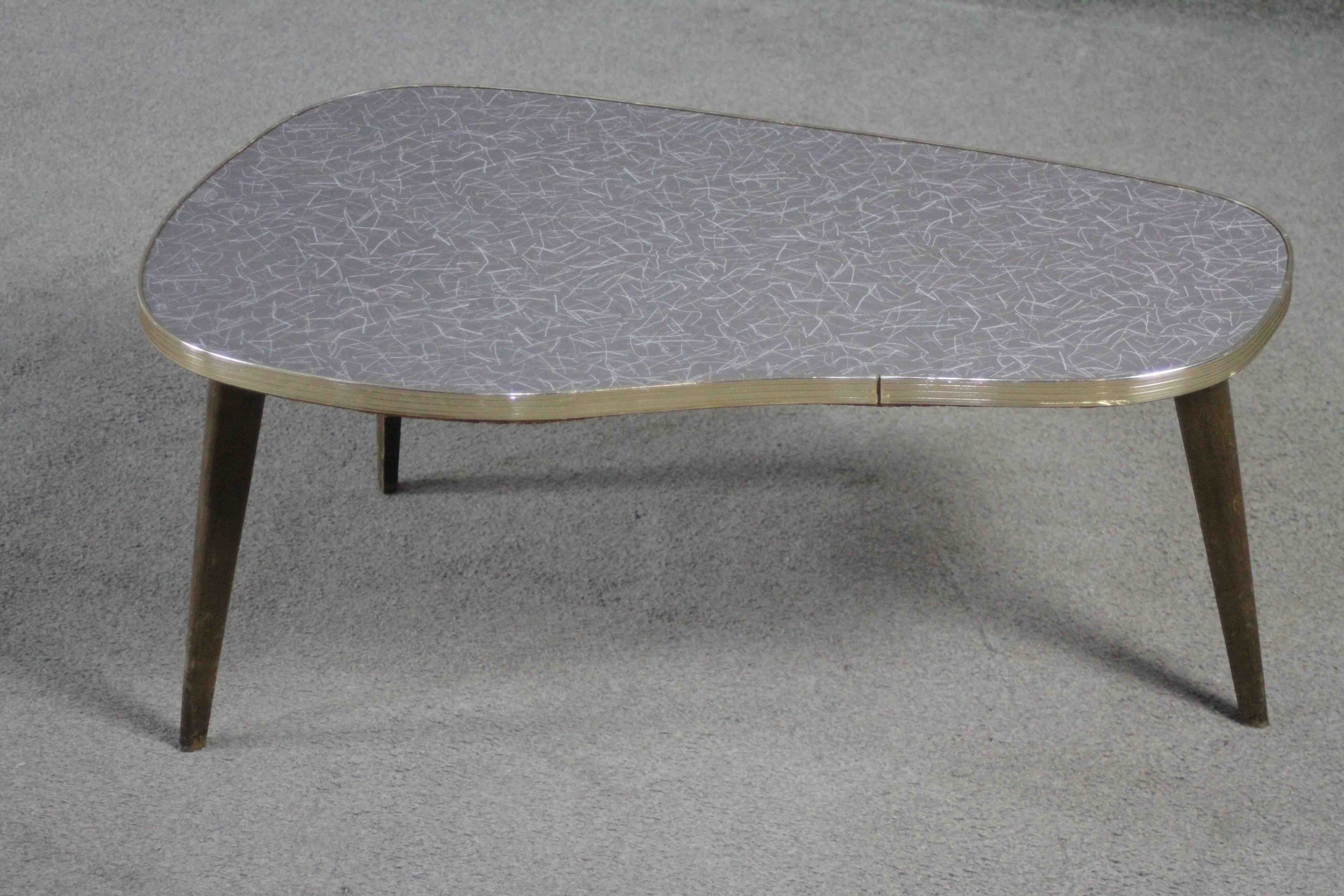 A mid century shaped coffee table with composite laminated top on splay supports. H.34 W.76 D.43 - Image 2 of 3