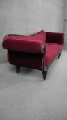 A Victorian mahogany scroll end chaise longue in velour upholstery on tapering faceted supports.