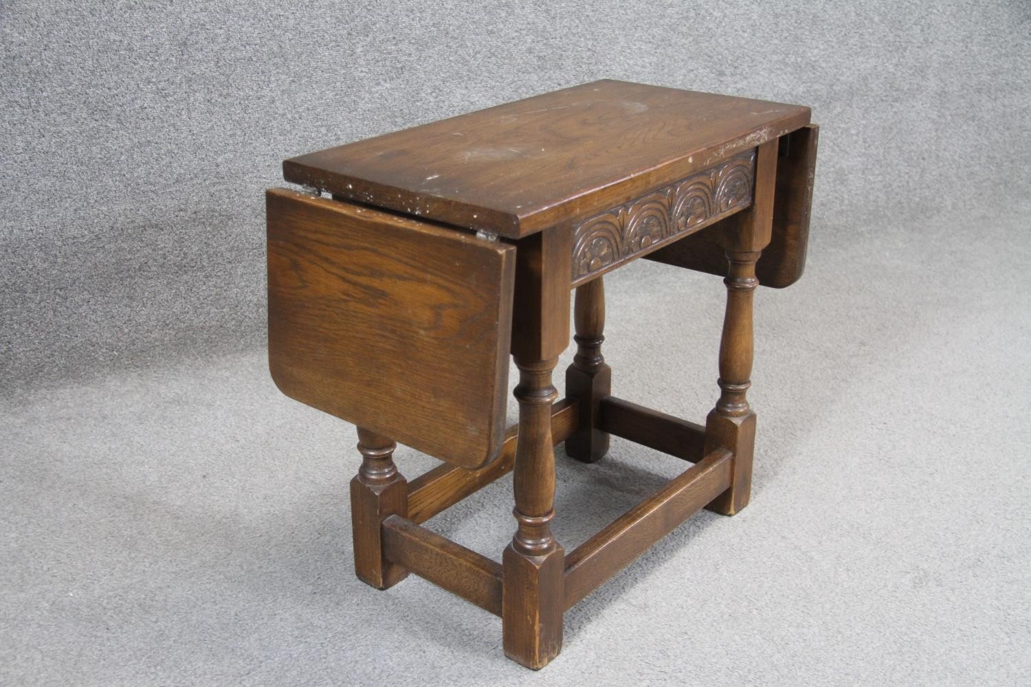 A small mid century oak Jacobean style twin drop flap occasional table with carved frieze on - Image 2 of 4