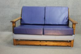 A vintage oak framed Ercol two seater sofa. H.80 W.13 D.90
