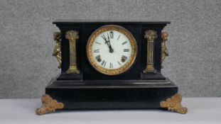 A C.1900 black slate mantle clock with figural ormolu detailing. Gilt metal column motifs to the