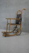 A late 19th century wheeled chair with bentwood frame. H.110 W.55