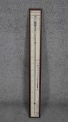 Barometer by Torricelli, with paper dial on oak panel. H.94 W.10cm