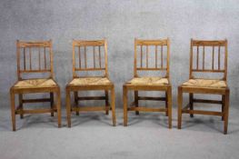 A set of four 19th century country elm and inlaid dining chairs with drop in woven rush seats. (Rush
