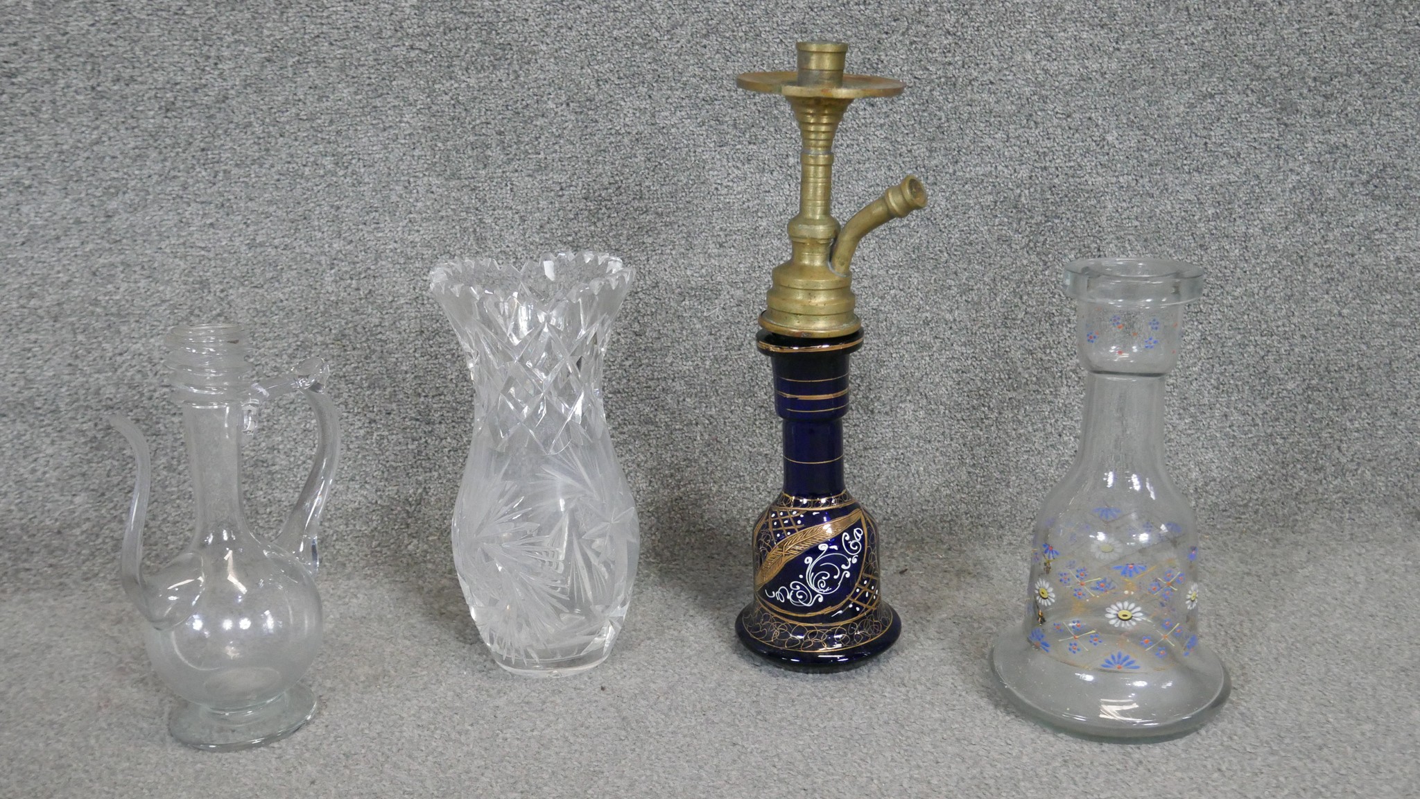 A collection of glassware. Including two hand painted hookah bases and a cut crystal vase. H. 39 (