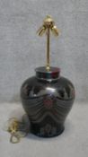 A large Eastern colourful transfer design black ceramic table lamp with brass double bulb fitting.