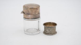 A silver lidded and cut glass perfume bottle with original stopper along with a engraved silver