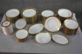 A Royal Copenhagen 9 carat gold hand painted twelve person dinner service. Makers stamp to the base.