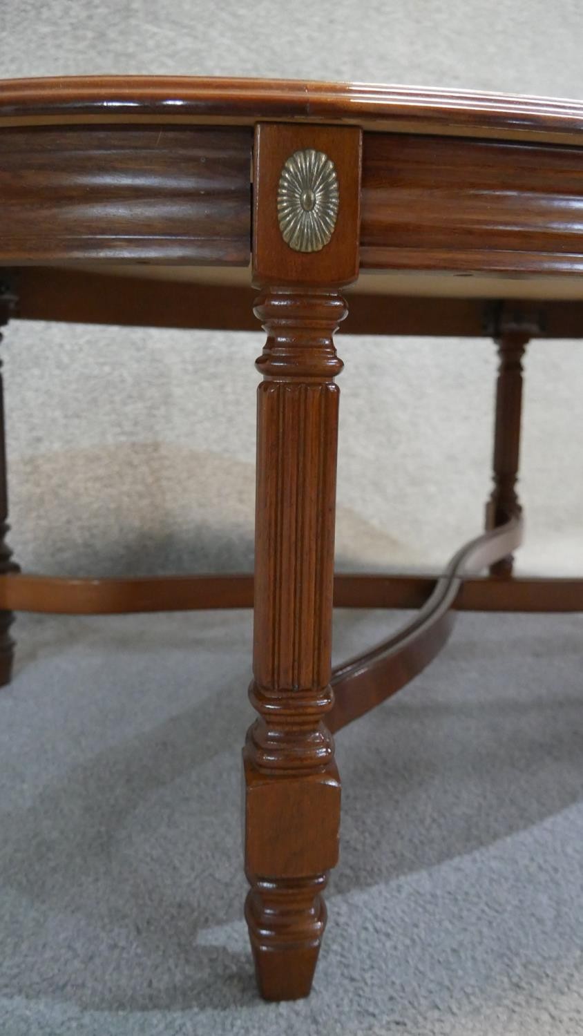 A Continental walnut and crossbanded low table on reeded stretchered supports. H. 44 W. 110 D.75 - Image 4 of 4