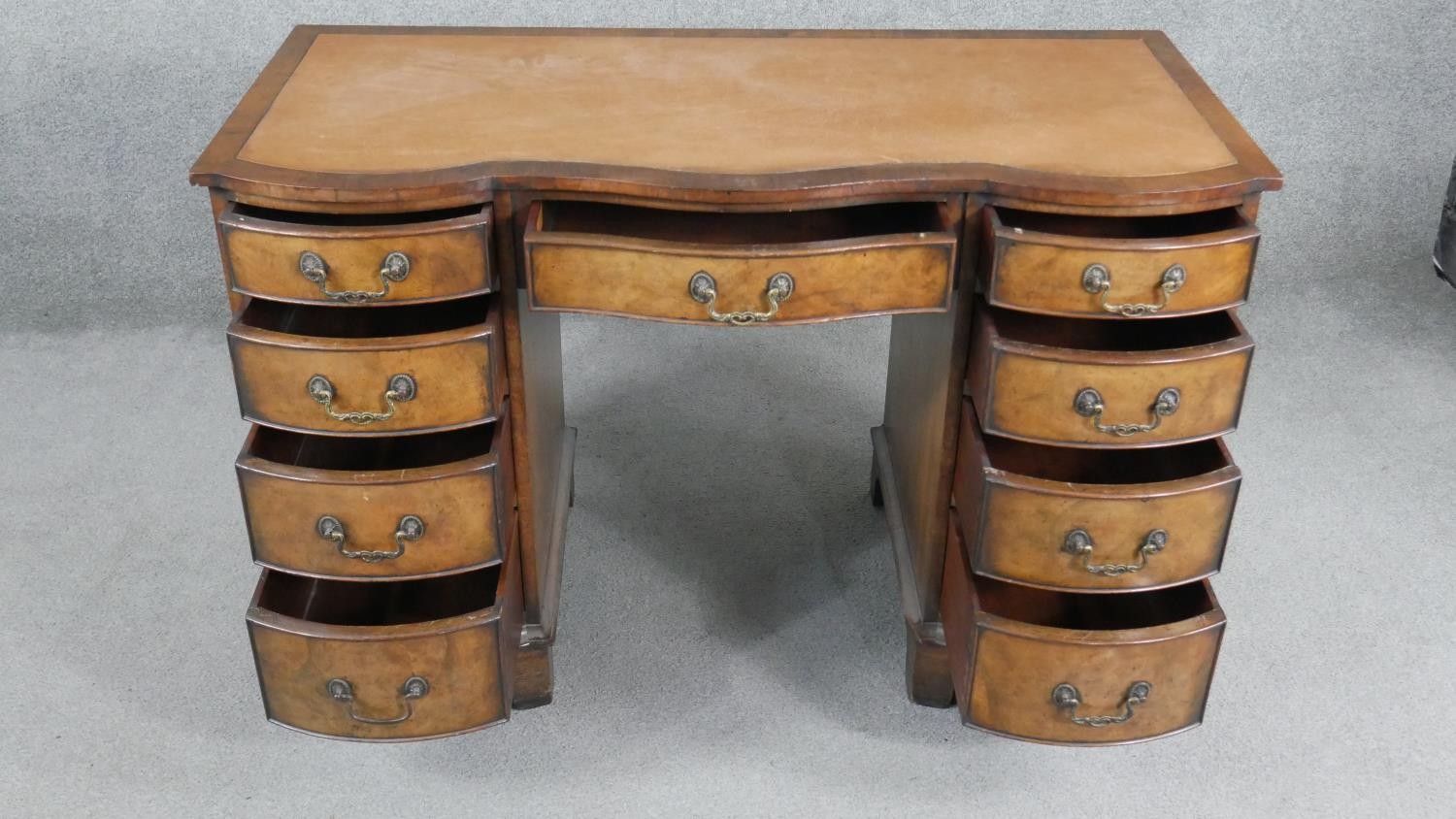 A Reprodux Georgian style figured mahogany pedestal desk with inset leather shaped top on shaped - Image 2 of 7