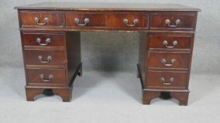 A Georgian style mahogany three part pedestal desk with inset tooled leather top. H180 W.136 D.67cm