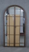 A metal framed arched garden mirror. H.170 W.90cm (Plate damaged as photographed)