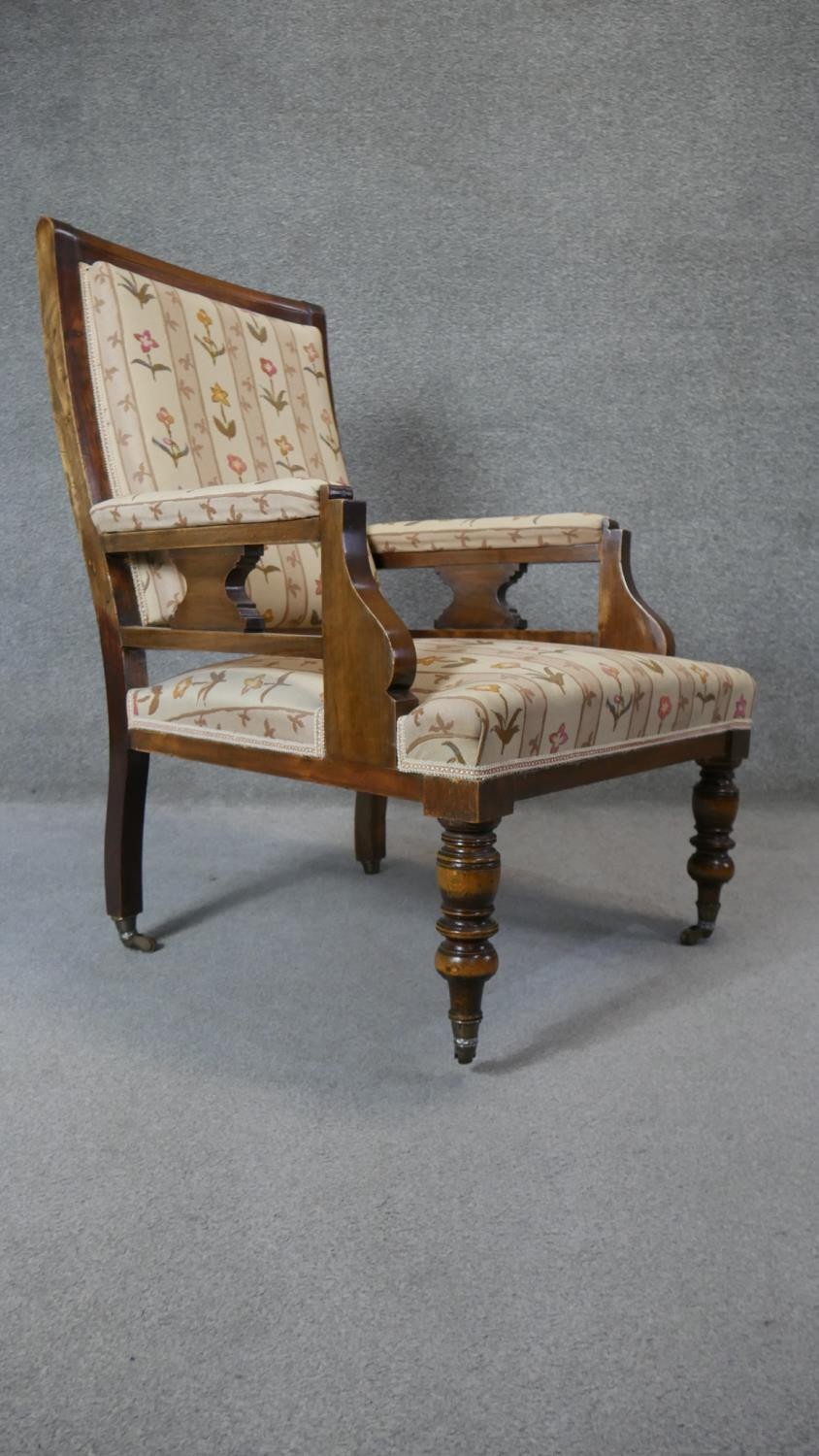 A late 19th century walnut framed armchair in floral upholstery on turned tapering supports. - Image 7 of 7