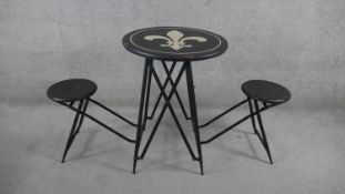 A folding metal garden or conservatory table with integral twin stools and Fleur de Lys