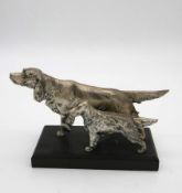 A silver plated Irish setter and puppy, intricately modelled mounted on a black wooden base. H.17